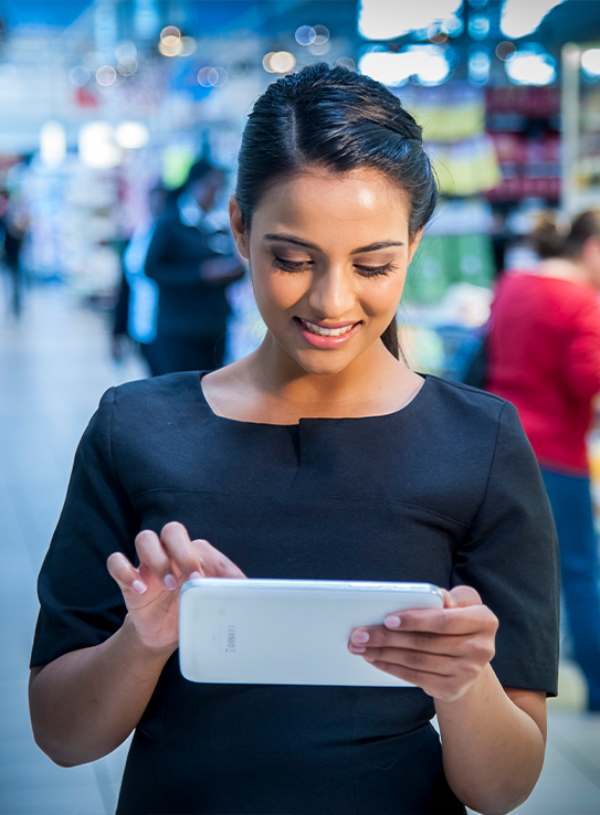 Merchandiser using a tablet in a store